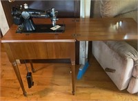 Singer sewing machine in cabinet