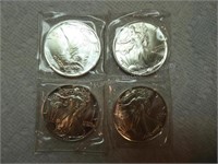 Four 1990 silver dollars