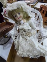 Bisque doll in wicker chair