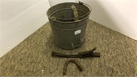Bucket of chain, hooks, leather straps