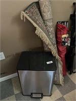 Trash can and area rug. Size unknown.