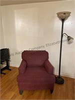 Floor lamp and cranberry accent chair.