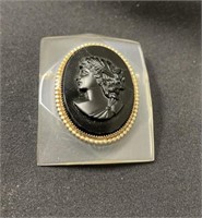 Gold-Rimmed Black Cameo Mounted in Lucite Brooch