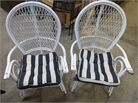 Two wicker patio chairs with cushions