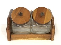 Two glass canisters in wooden caddy