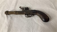 Vintage brass flintlock pistol with wood handle