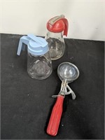 Group of vintage syrup dispensers and scoop