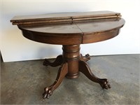 Antique oak dining table with carved base