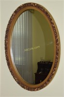 Oval gold framed mirror. 26 1/2hX 18 1/2w