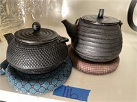 Two cast iron oriental tea pots - with tea basket