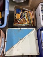 Assortment Of Pencils And Roller Skates In Case
