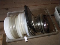 Container of lids and bowl and trays