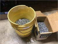 Box and plastic bucket of roofing nails