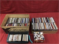 2 boxes of CDs and a case of cassette tapes by