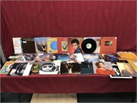 Assortment of records with artists such as
