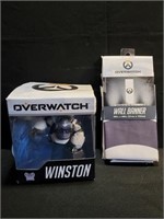 Overwatch Winston figurine and an Overwatch banner