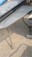 About 40" square glass top patio table