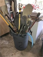 Rubbermaid trash can with garden tools