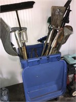 Trash can with garden tools