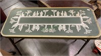 Small tin folding table with a green and white