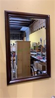 Medium size framed beveled wall mirror. Measures