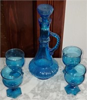 blue glass decanter and glasses