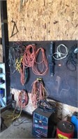 Jumper cables, extension chords, on peg board