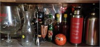 lot of bar glasses, bottles and decor