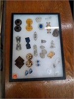 VINTAGE BUCKLES IN A DISPLAY CASE AND SPECTACLES