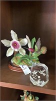 Small hummingbird and flower stature with glass