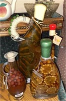 4 DECORATIVE BOTTLES OF PICKLED ITEMS