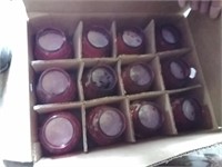 12 red table top candles.  Venus candles
