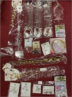 15 pieces of costume jewelry and a bag of 11