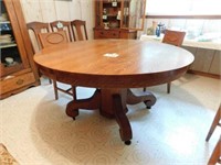 54" round oak table, 4 legs from center pedestal,