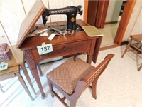 Vintage Singer sewing machine in walnut cabinet