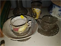 lot of glasses , tea cup , shaker , cutlery , etc