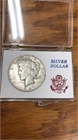 1927 Peace silver dollar coin in case