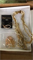 Two toned costume necklaces and earrings in box