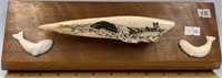 A colored scrimshawed fossilized walrus Ivory arti