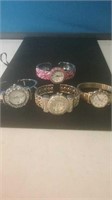 Group of three bracelet wrist watches and one