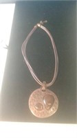Leather string necklace with pendant encasing t