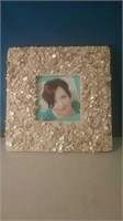 Photo frame with attached shell pieces