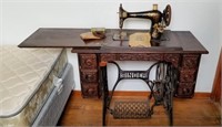 Singer sewing machine in cabinet with accessories