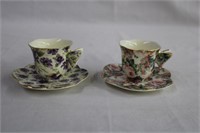 Two butterfly handled demi tasse cups and saucers