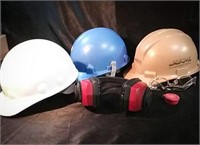 Three hard hats, hearing protection, and safety