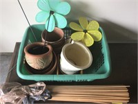 Assorted clay pots and dowel plant stakes