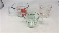 Two Pyrex and one Fire King measuring cups