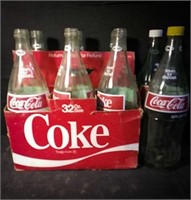 Six pack of glass 32 oz Coca-Cola bottles in a