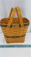 Oval Longaberger basket with dual handles.