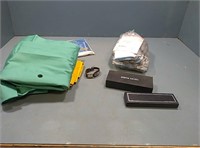 Box with gloves, shirt, pens, watch, and more